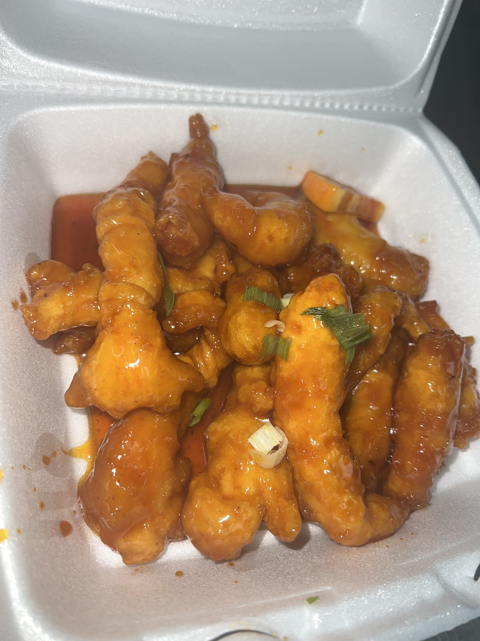 Crispy chicken glazed in a sweet sauce with scallions